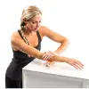 Women rolling out her arm with the TriggerPoint NANO Roller