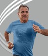 Man running, with visibly sweaty shirt